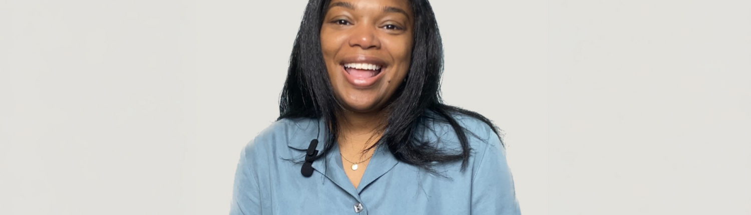 Headshot of Beatrice C. Henry, a smiling woman with long dark hair, wearing a light blue button-up shirt.